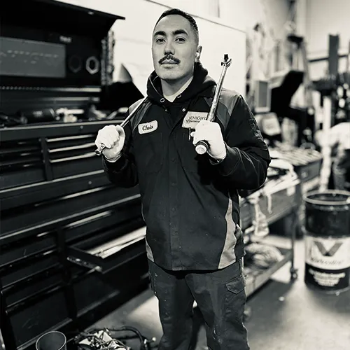 Expert mechanic inspecting under a car