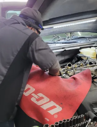 tech working on car engine