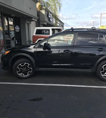 black subaru in a parking lot