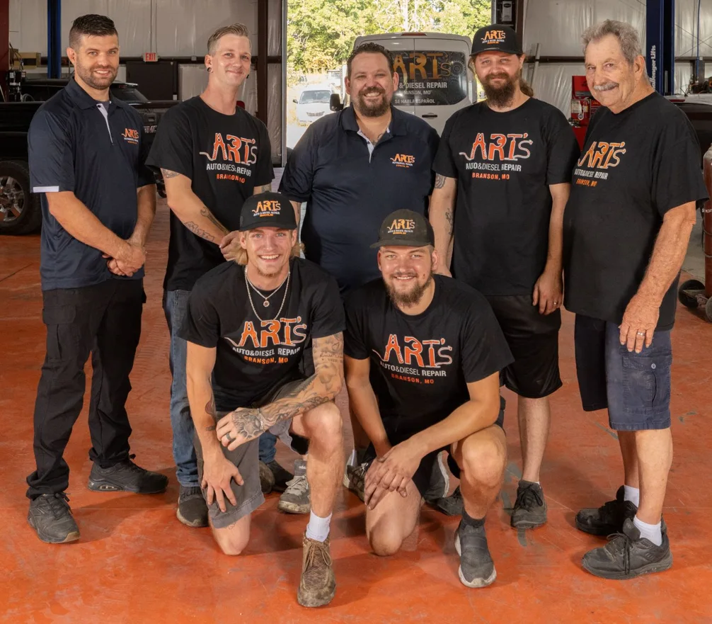 yellow corvette in front of auto shop