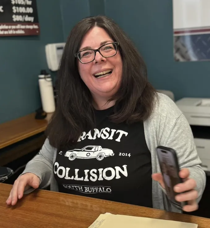 woman smiling sitting at a desk