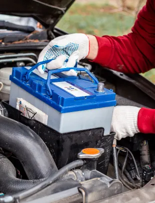tech working on car engine